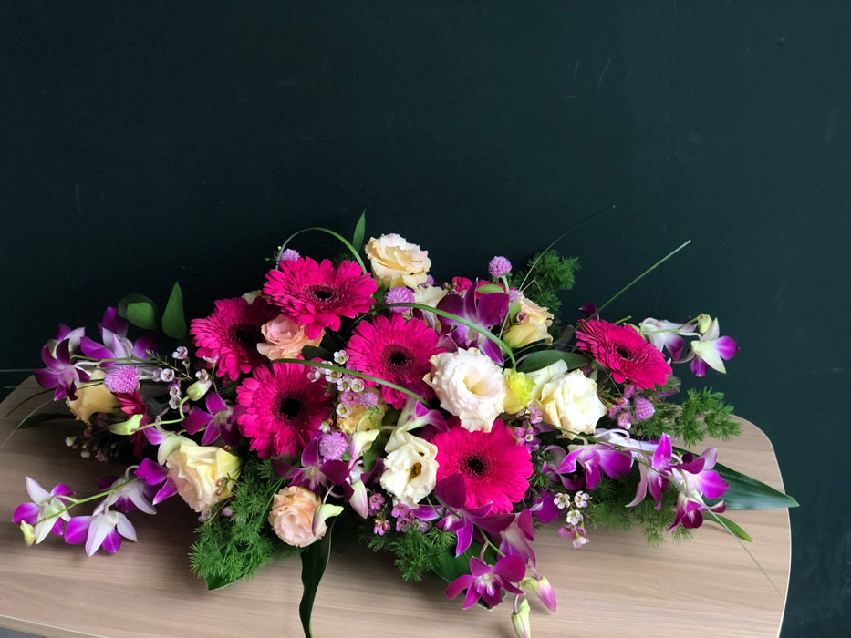 Pink Gerbera, Purple Two-Toned Dendrobium and  Champagne Eustomas Table Arrangement