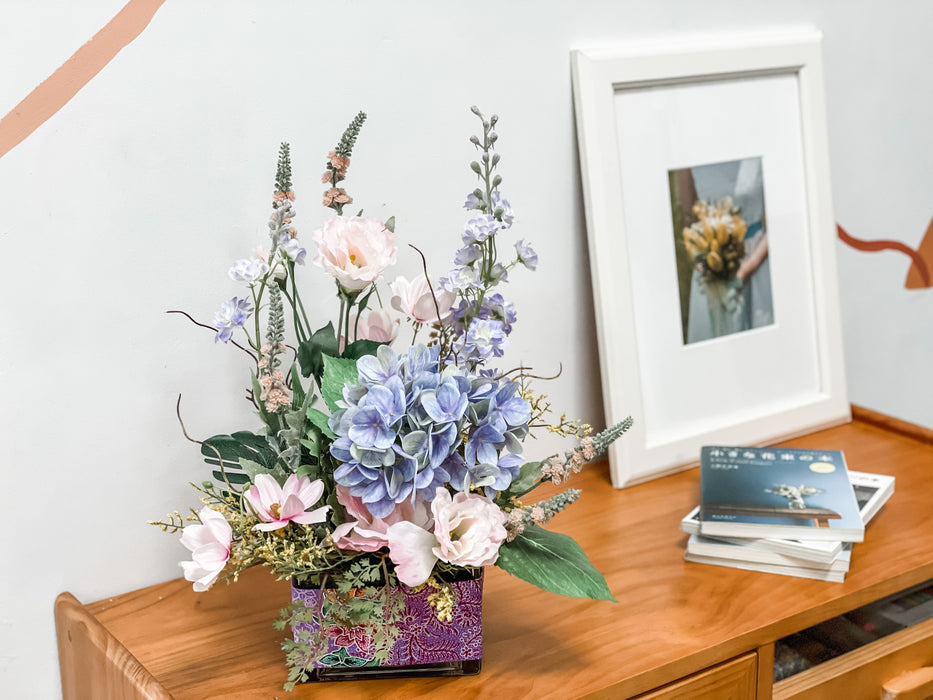 Faux Blue Hydrangeas and Lilac Delphiniums In A Batik-Wrapped Square Vase