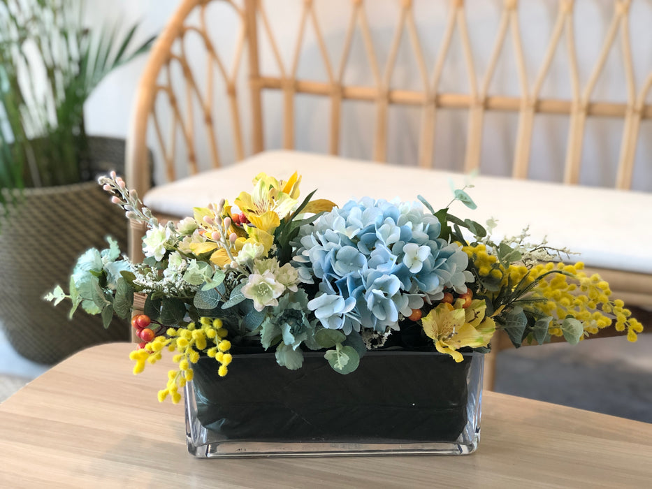 Faux Blue Hydrangeas and Yellow Alstromerias In A Long, Low Vase