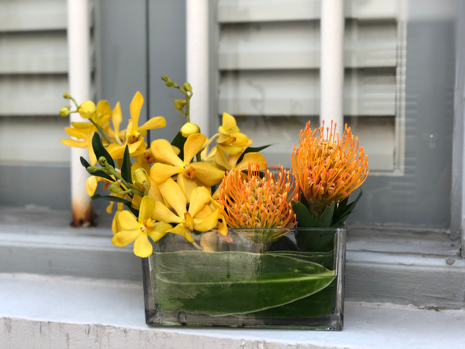 Orange Pin Cushion & Yellow Mokara Orchid Table Arrangement